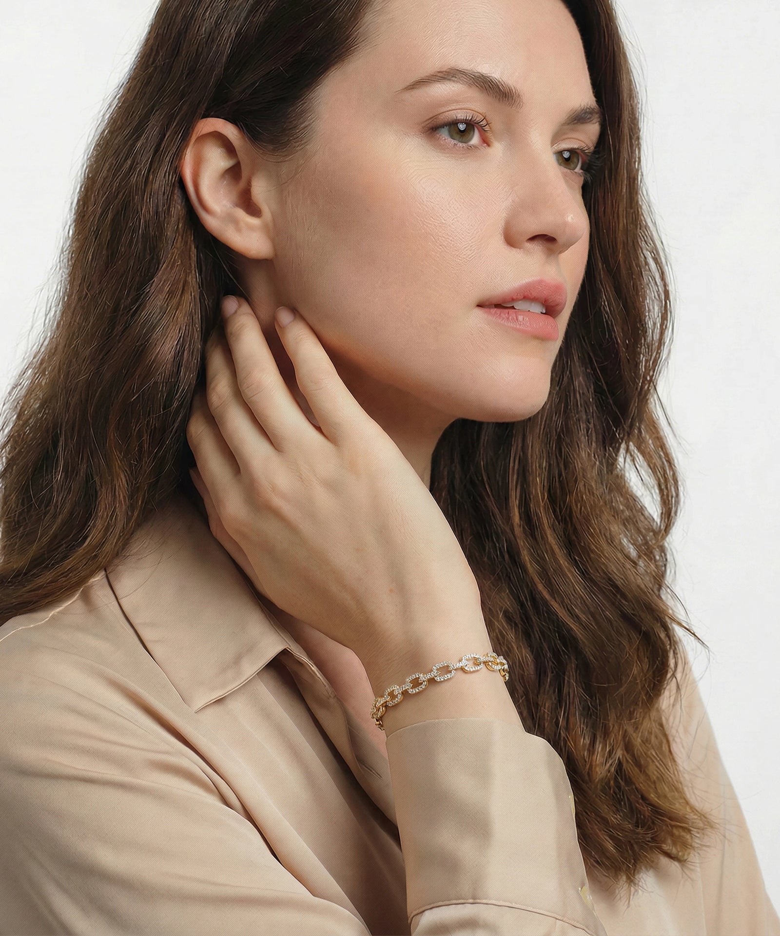 Woman wearing a bracelet on a plain background