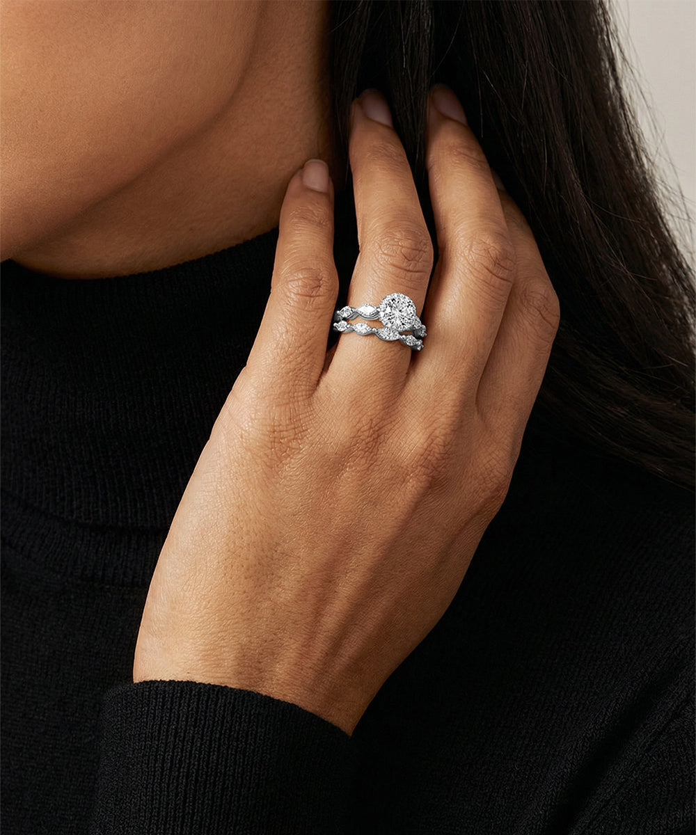 Close-up of a hand wearing a diamond ring with a blurred background
