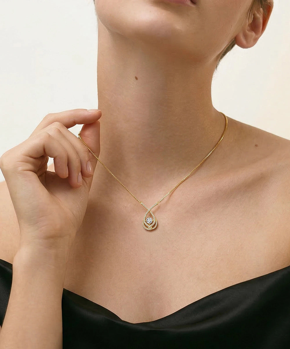 Necklace with a pendant worn by a person against a neutral background