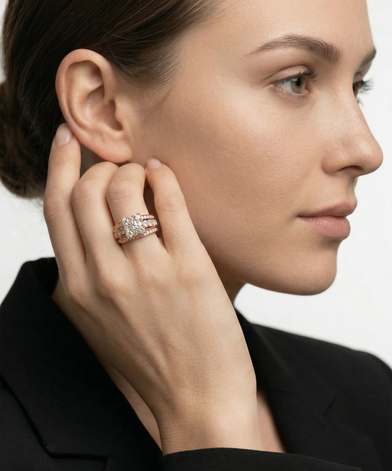 Close-up of a woman wearing a ring on her hand with a neutral background