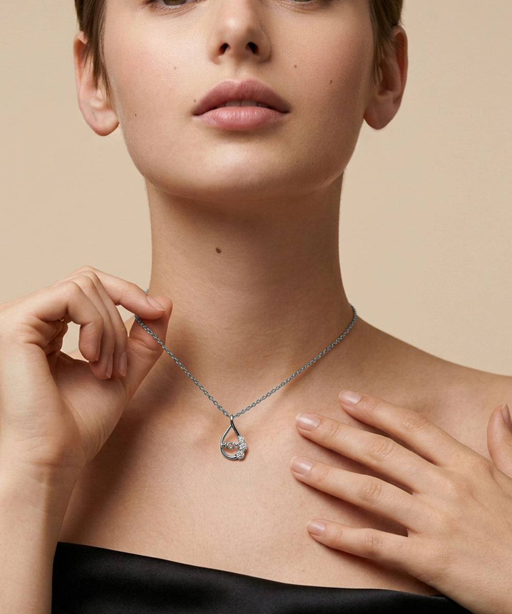 Woman wearing a delicate necklace against a beige background