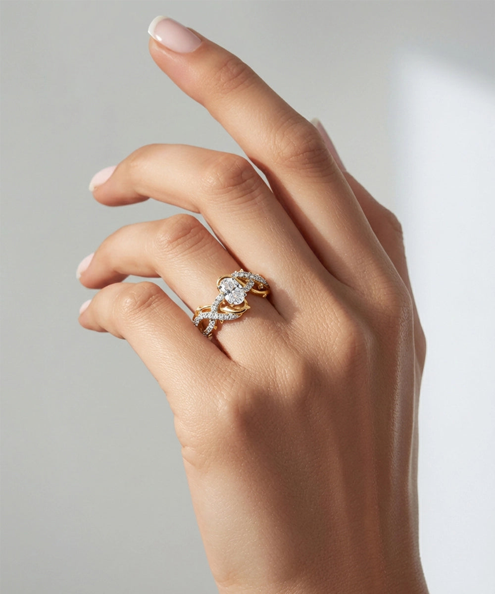 Hand wearing a gold and diamond ring on a neutral background