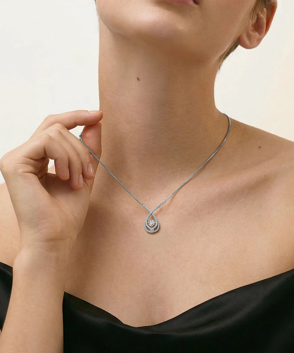 Necklace with a pendant worn by a person against a neutral background