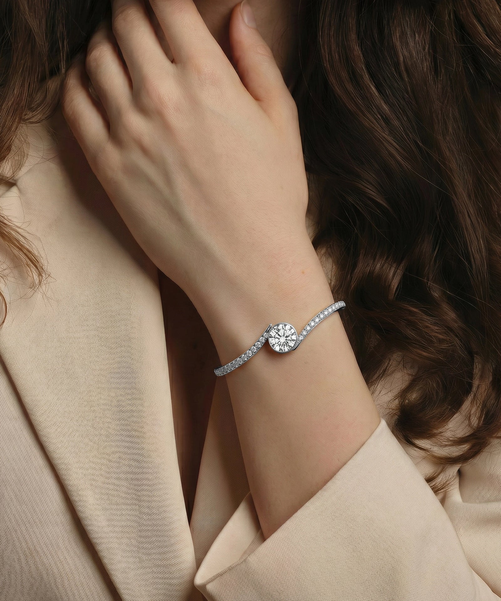 Close-up of a hand wearing a silver bracelet with a diamond on a neutral background