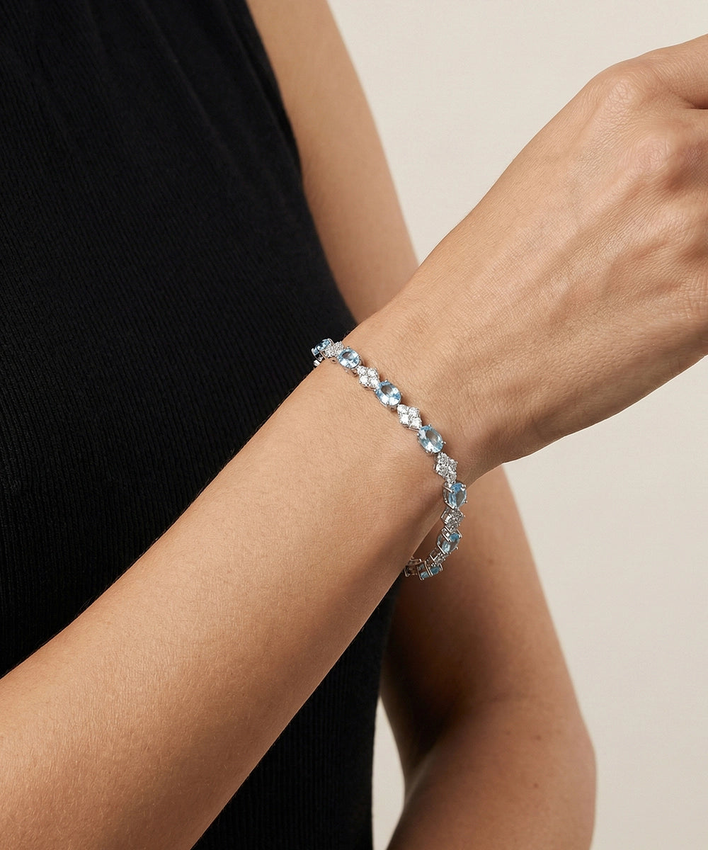 Close-up of a person wearing a bracelet with a neutral background