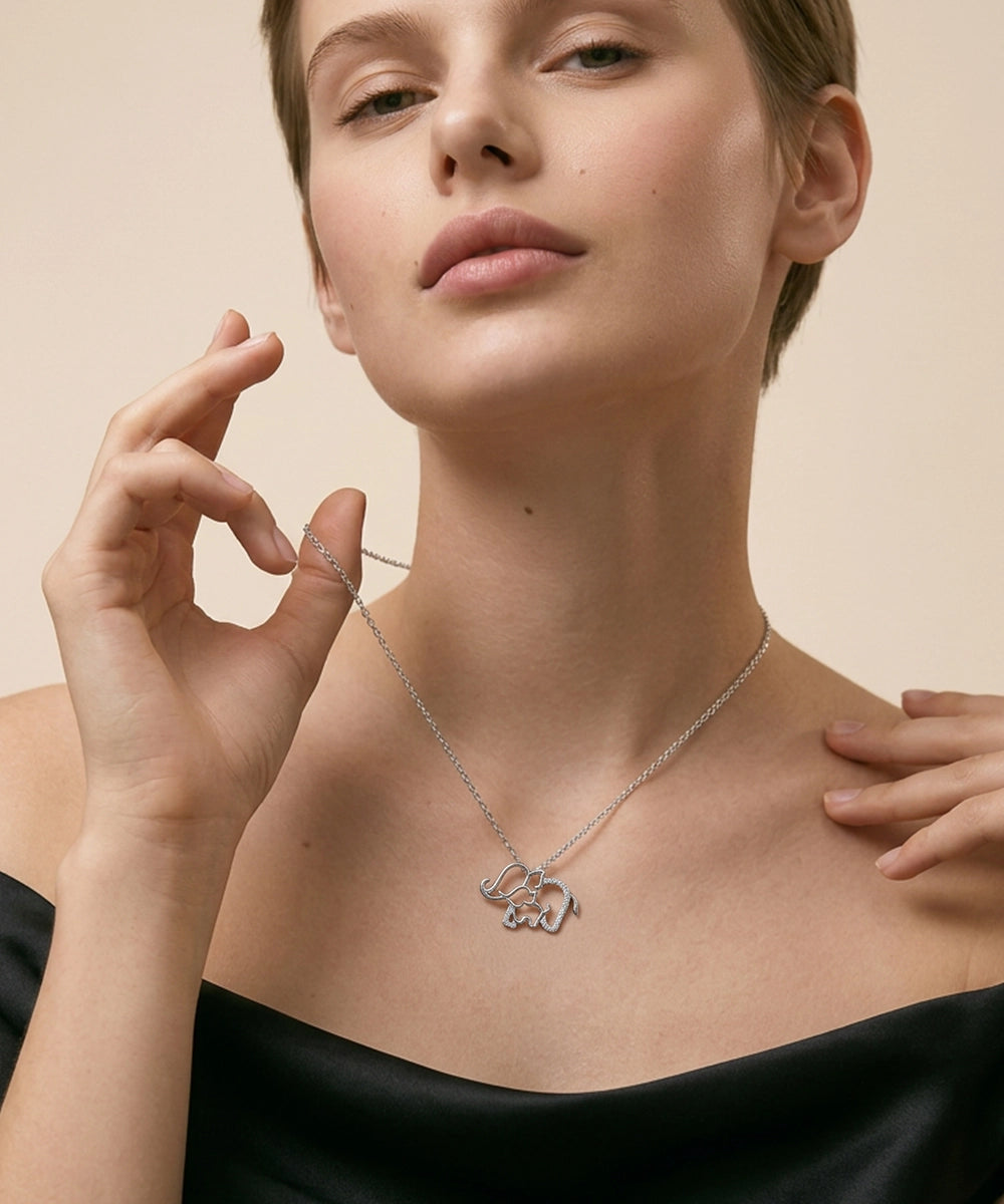 Woman wearing a silver necklace with a pendant on a beige background