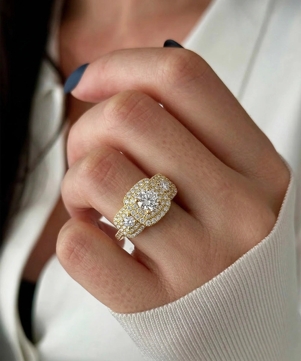 Close-up of a hand wearing a gold and diamond ring.