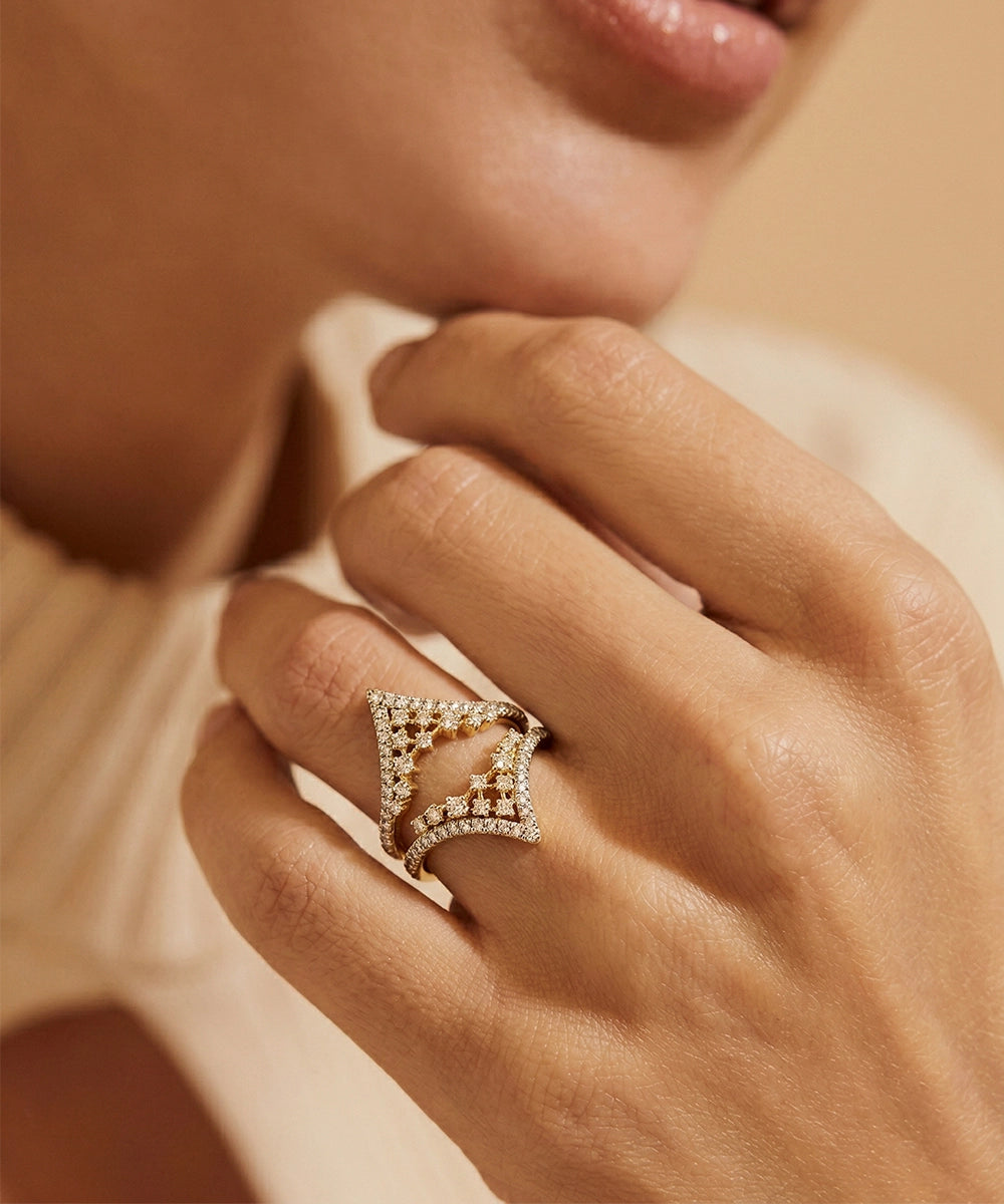 Close-up of a hand wearing a diamond ring with a blurred background