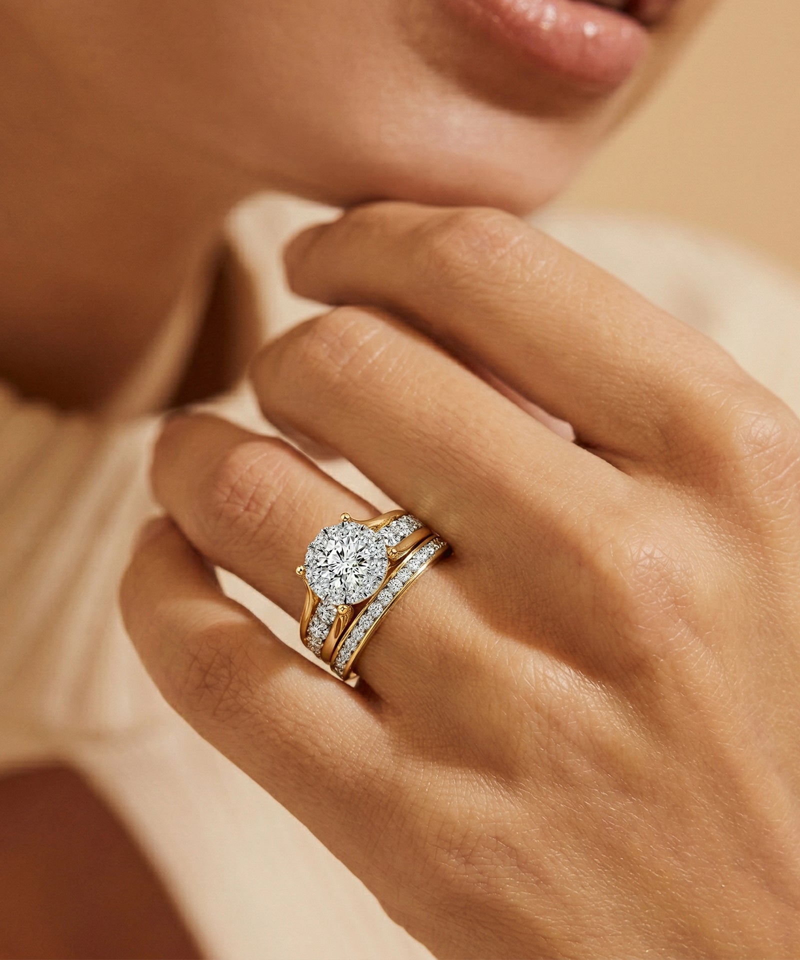 Close-up of a hand wearing a diamond ring with a soft focus background