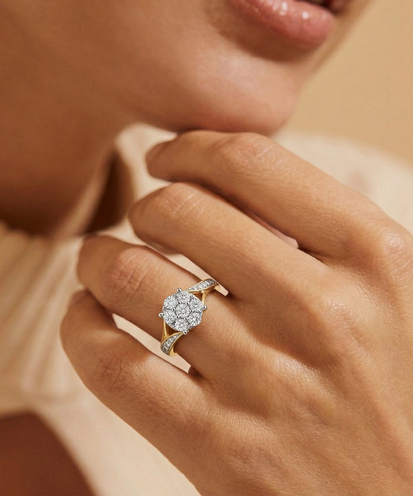Close-up of a hand wearing a diamond ring with a soft background