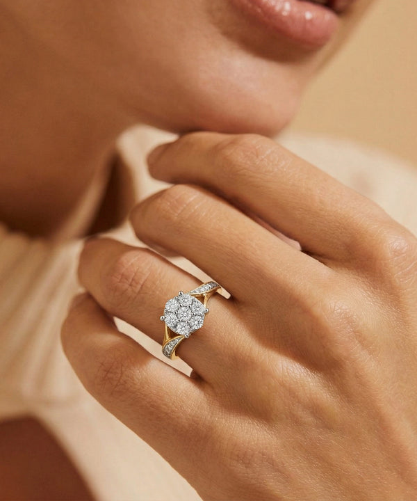 Close-up of a hand wearing a diamond ring with a soft background