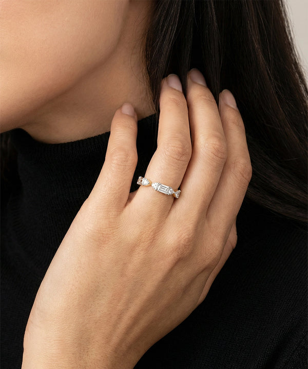 Close-up of a hand wearing a ring with a blurred background