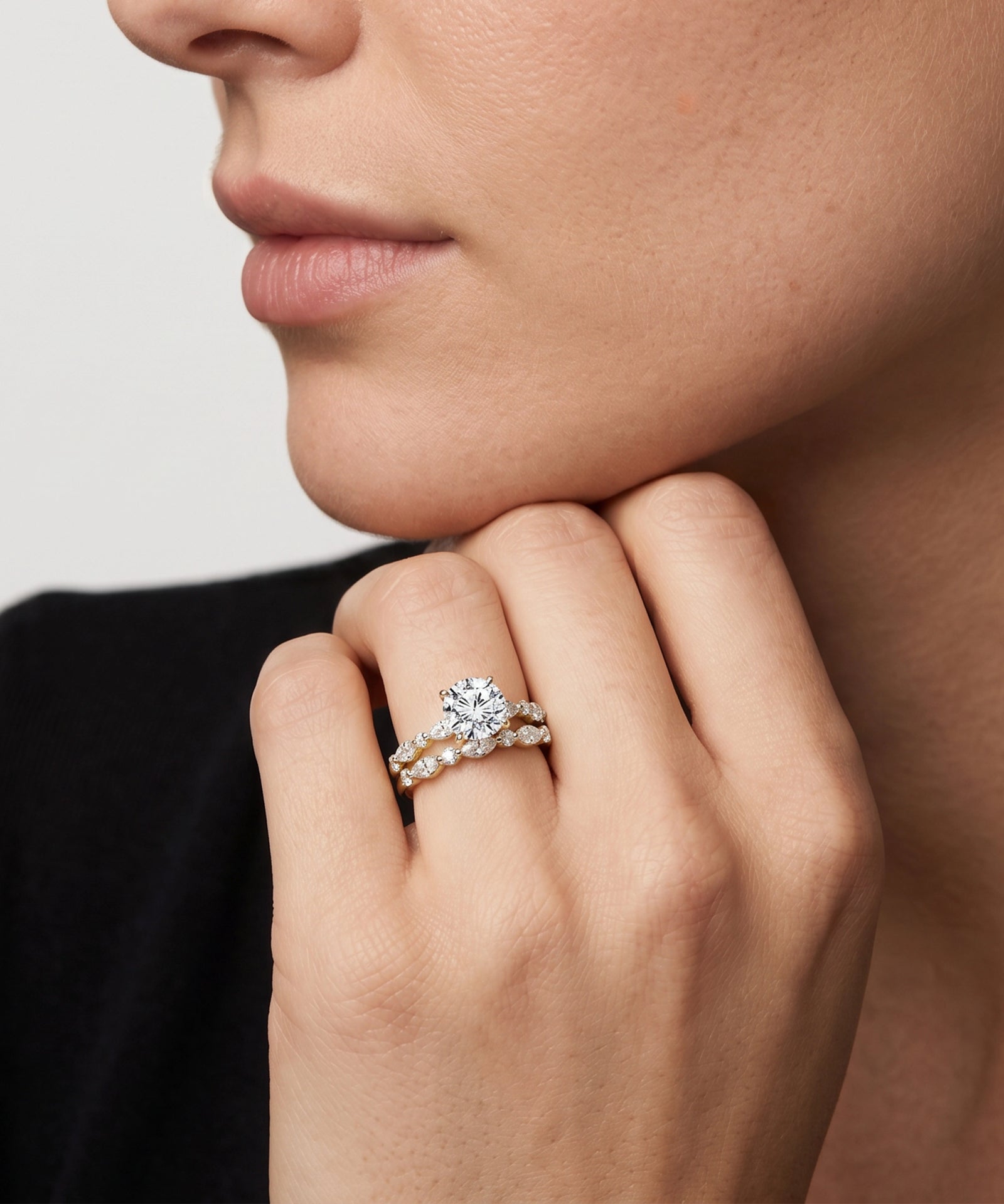 Close-up of a hand wearing a diamond ring with a blurred background