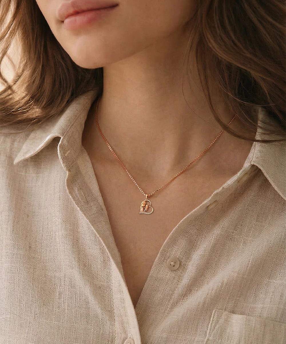 Necklace with a heart pendant worn by a person in a beige shirt