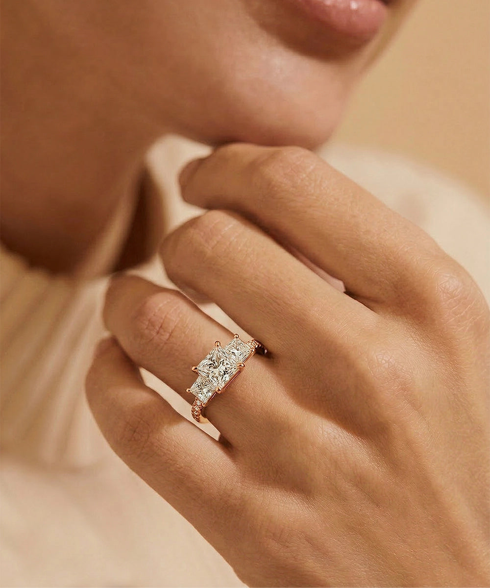 Close-up of a hand wearing a diamond ring with a soft focus background