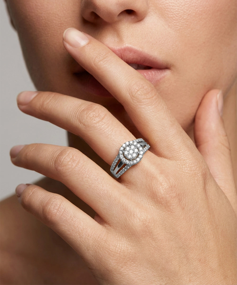 Close-up of a hand wearing a diamond ring with a neutral background