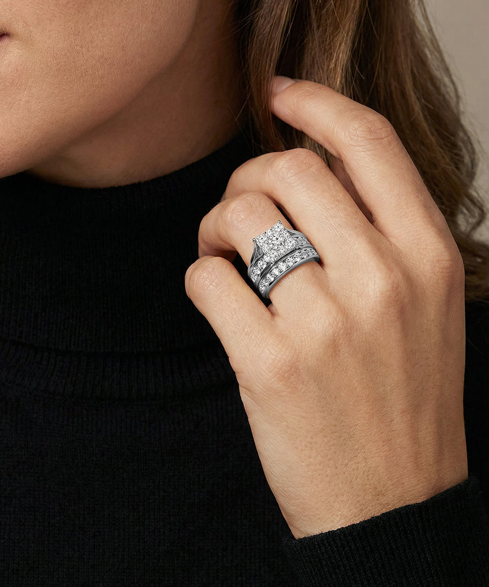 Close-up of a hand wearing a silver ring with a black background