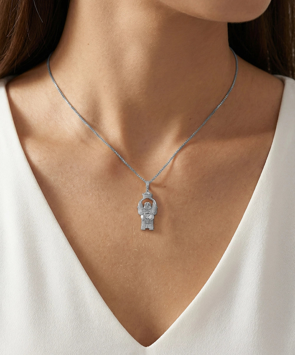 Silver necklace with a pendant worn by a person in a white top