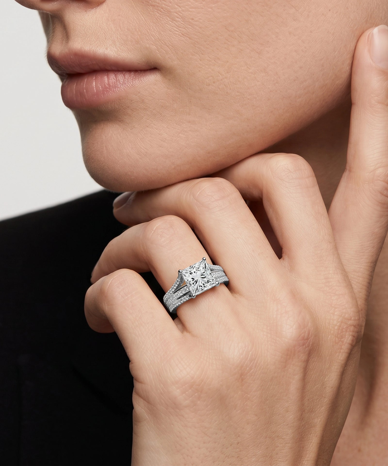Close-up of a hand wearing a diamond ring with a blurred background