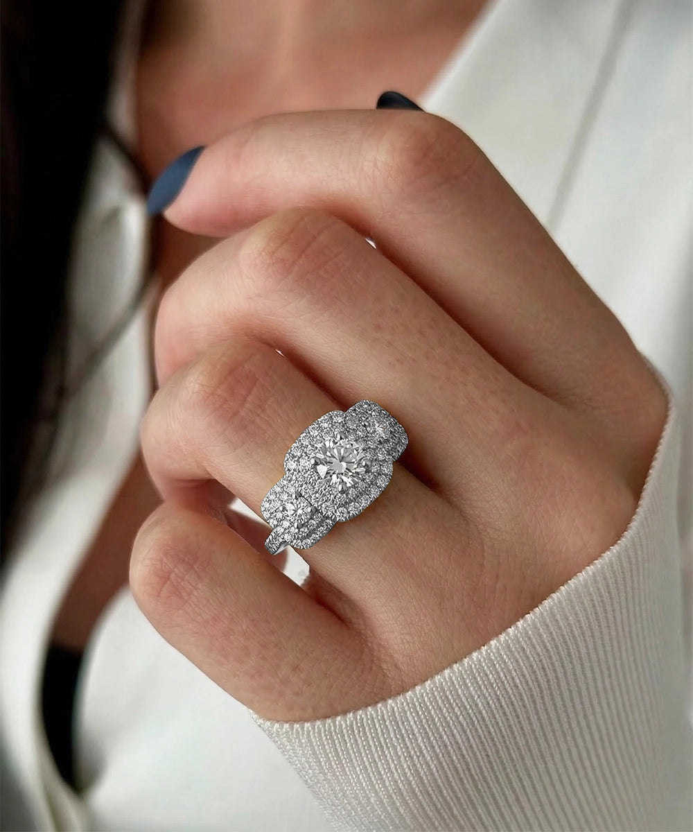 Close-up of a hand wearing a diamond ring with a blurred background