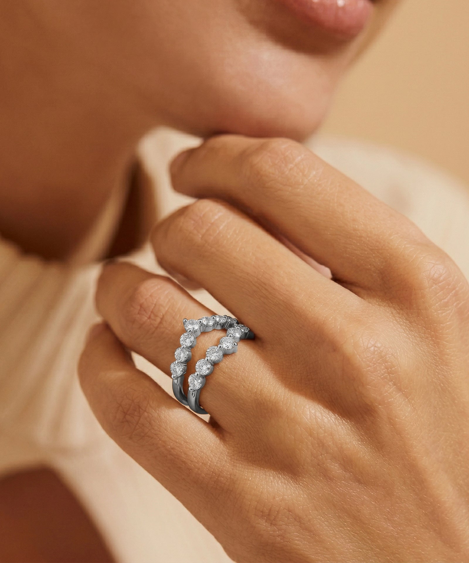 Close-up of a hand wearing a silver ring with a blurred background