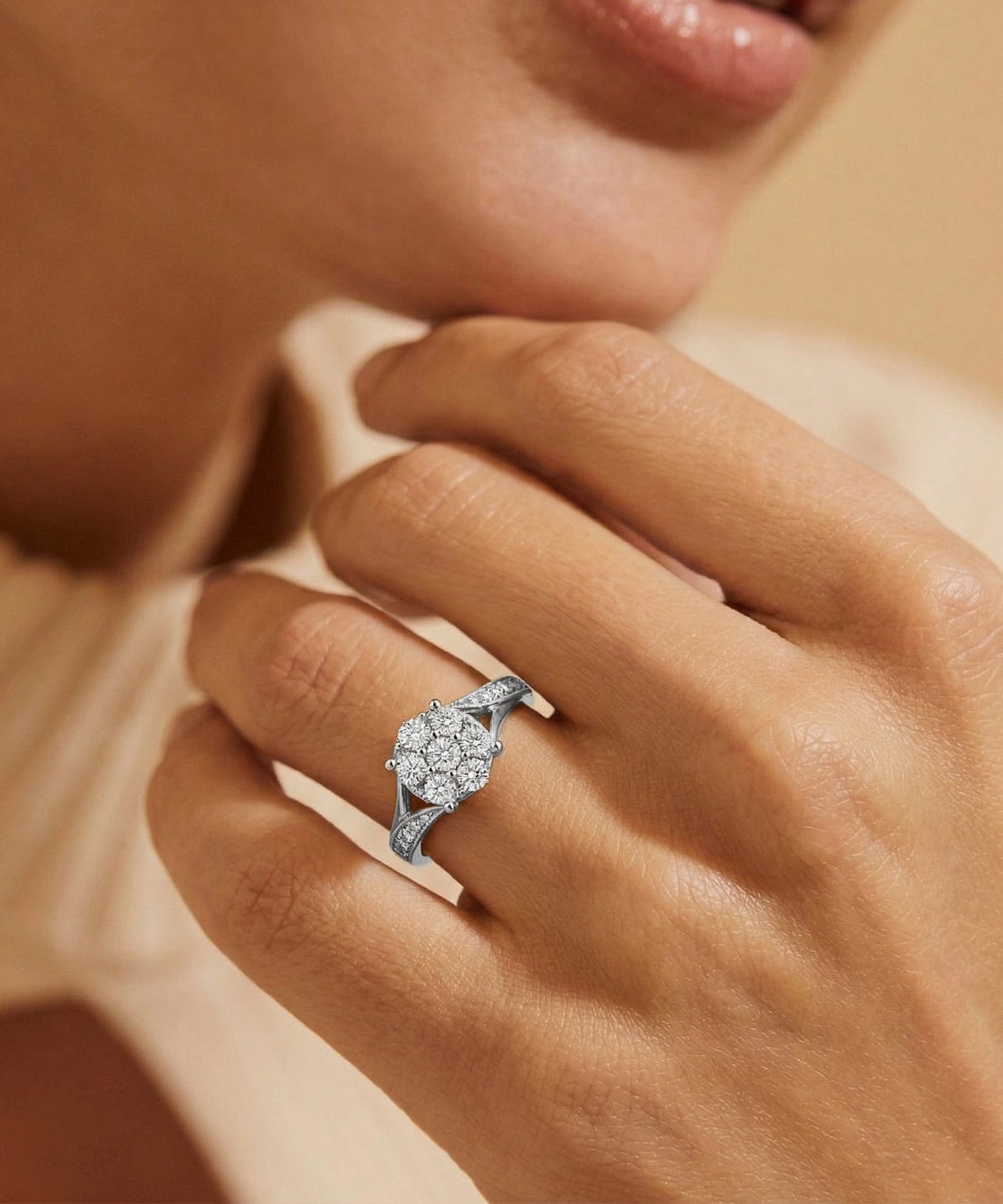 Close-up of a hand wearing a diamond ring with a soft focus background