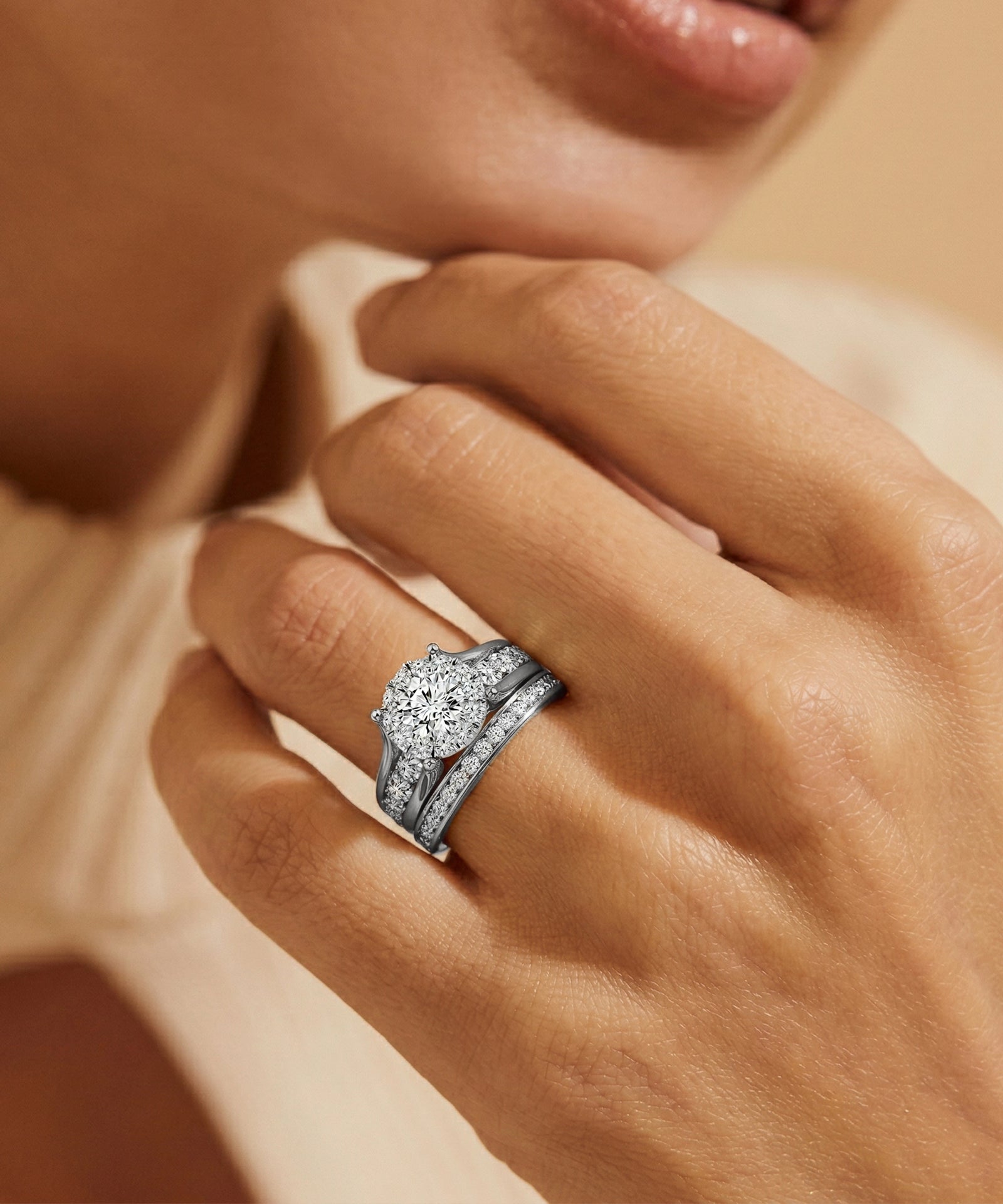 Silver ring with a diamond on a hand against a neutral background