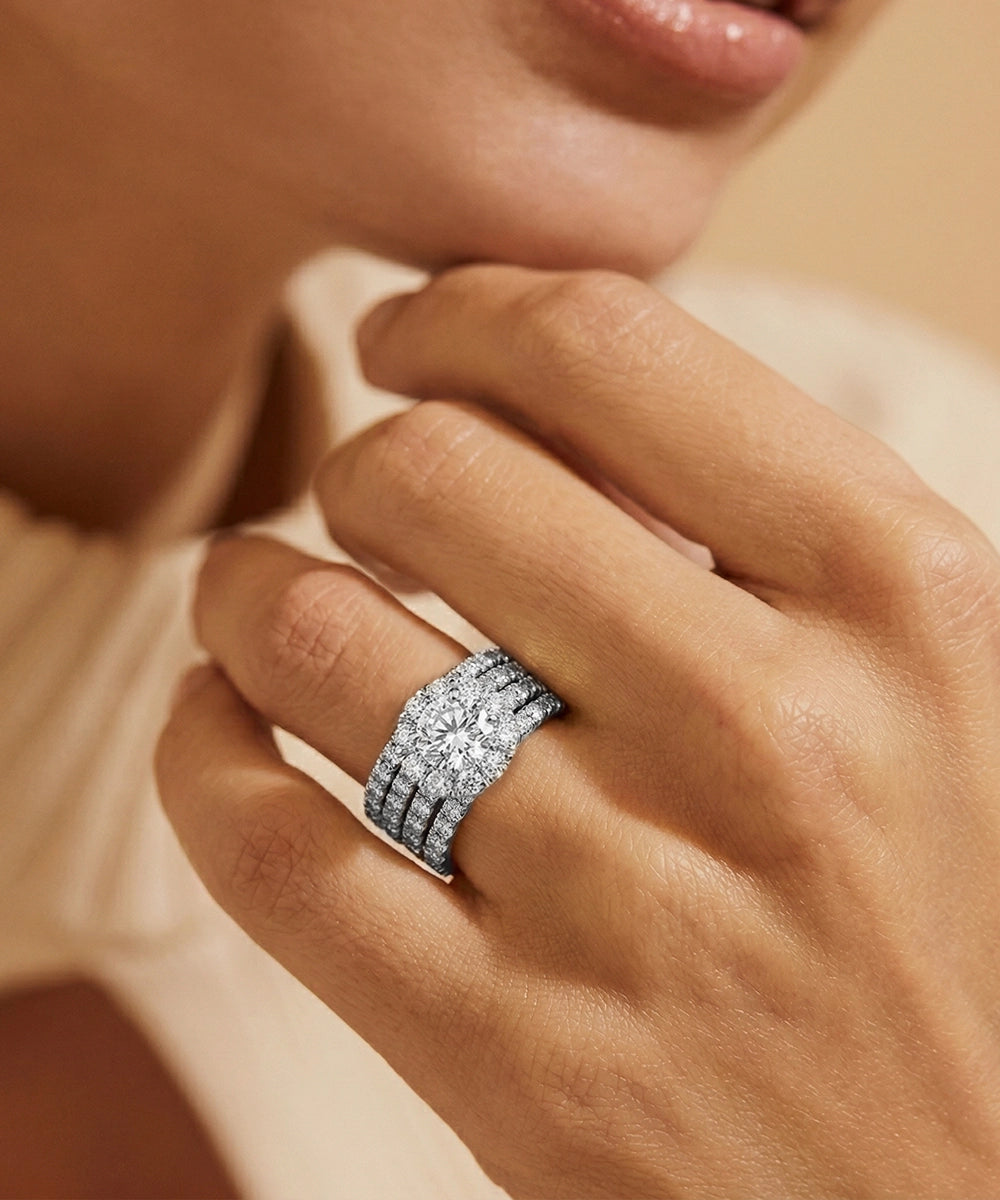 Close-up of a hand wearing a diamond ring with a soft focus background