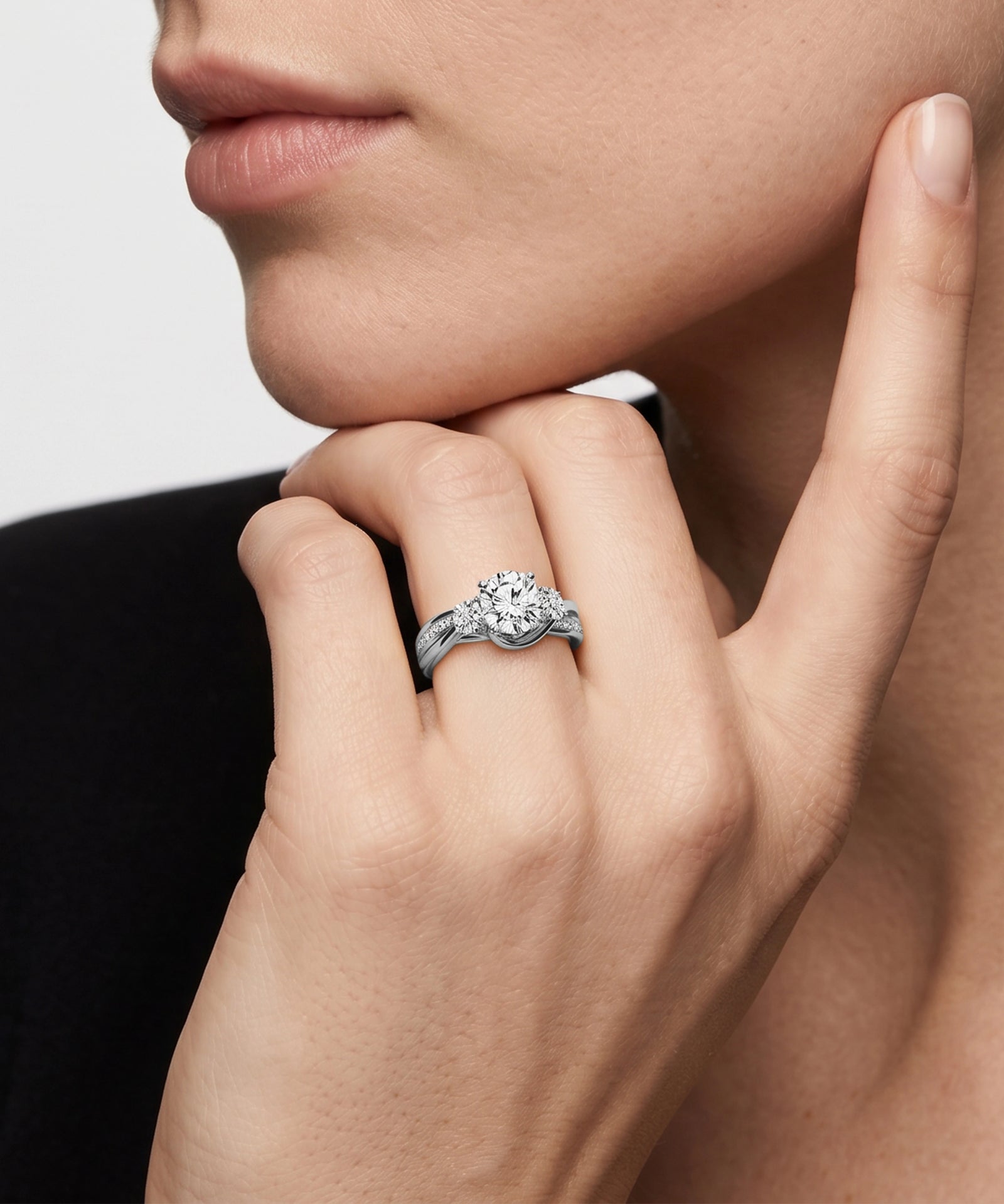 Close-up of a hand wearing a diamond ring with a neutral background