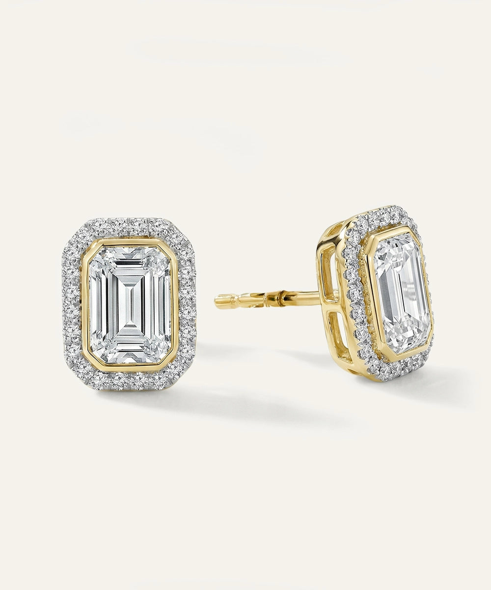 Pair of gold and diamond earrings on a white background