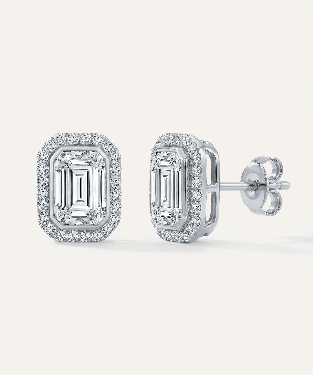 Pair of diamond earrings on a white background