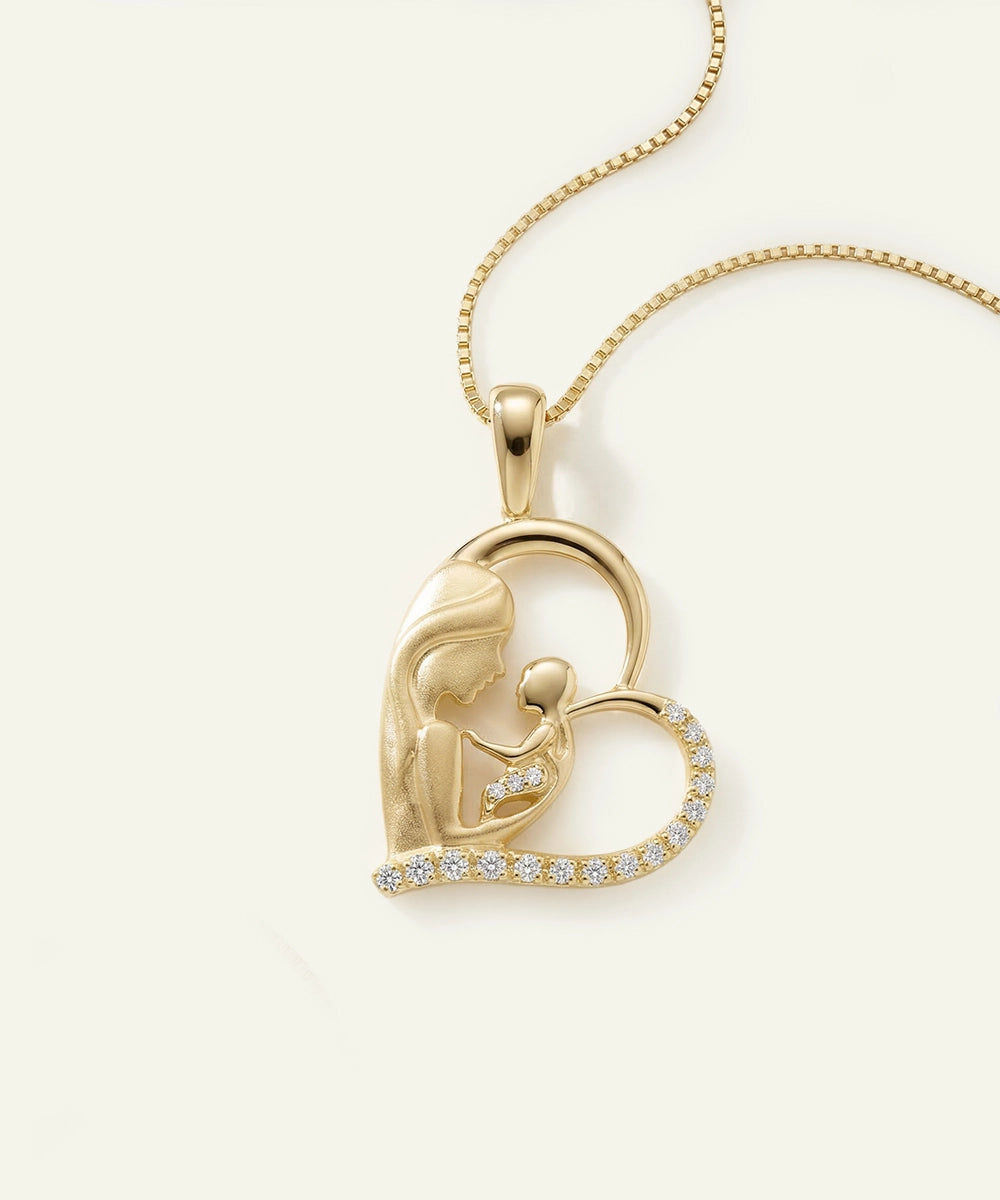 Gold pendant with heart design and diamond accents on a light beige background
