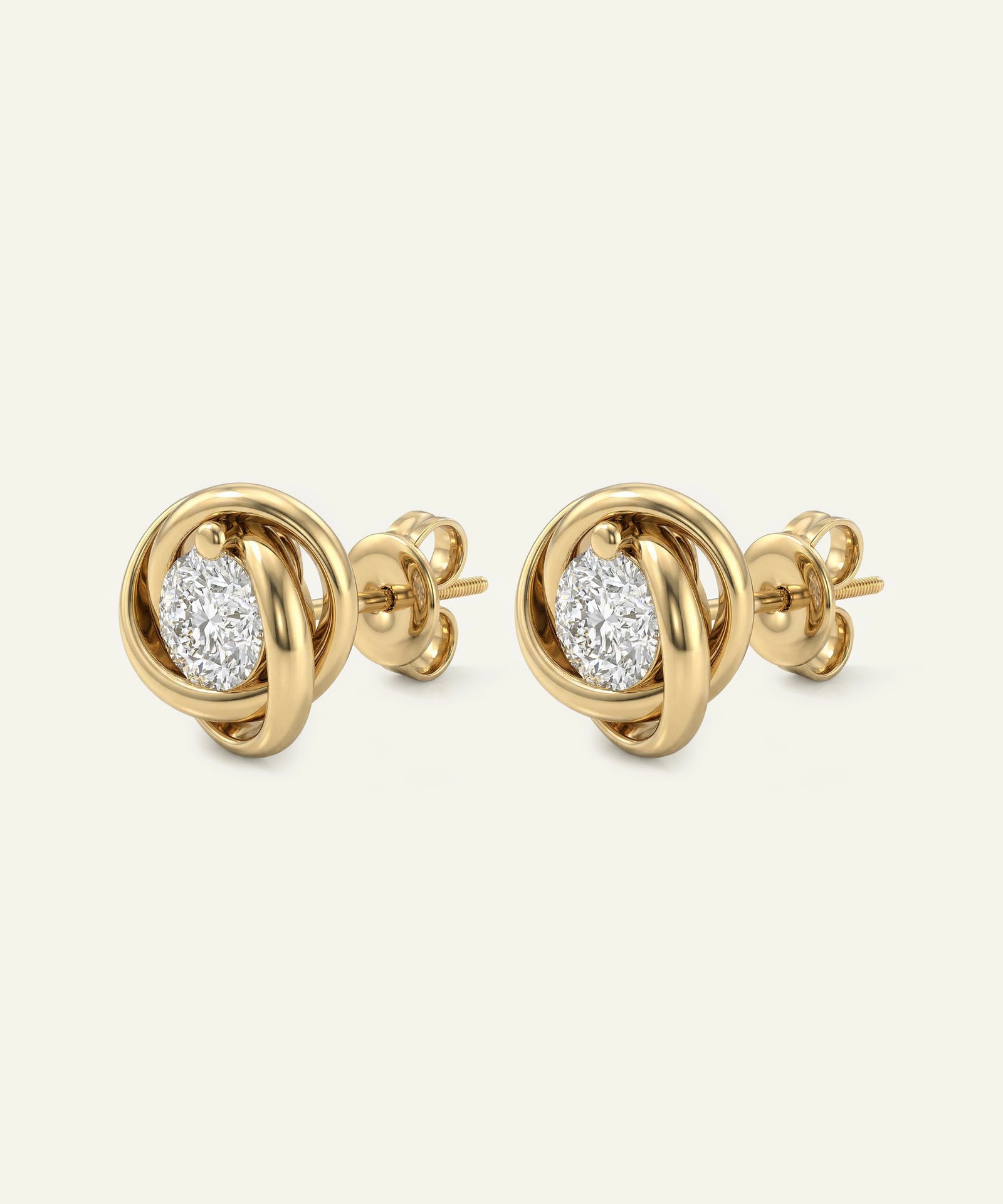 Gold earrings with diamond-like stones on a white background