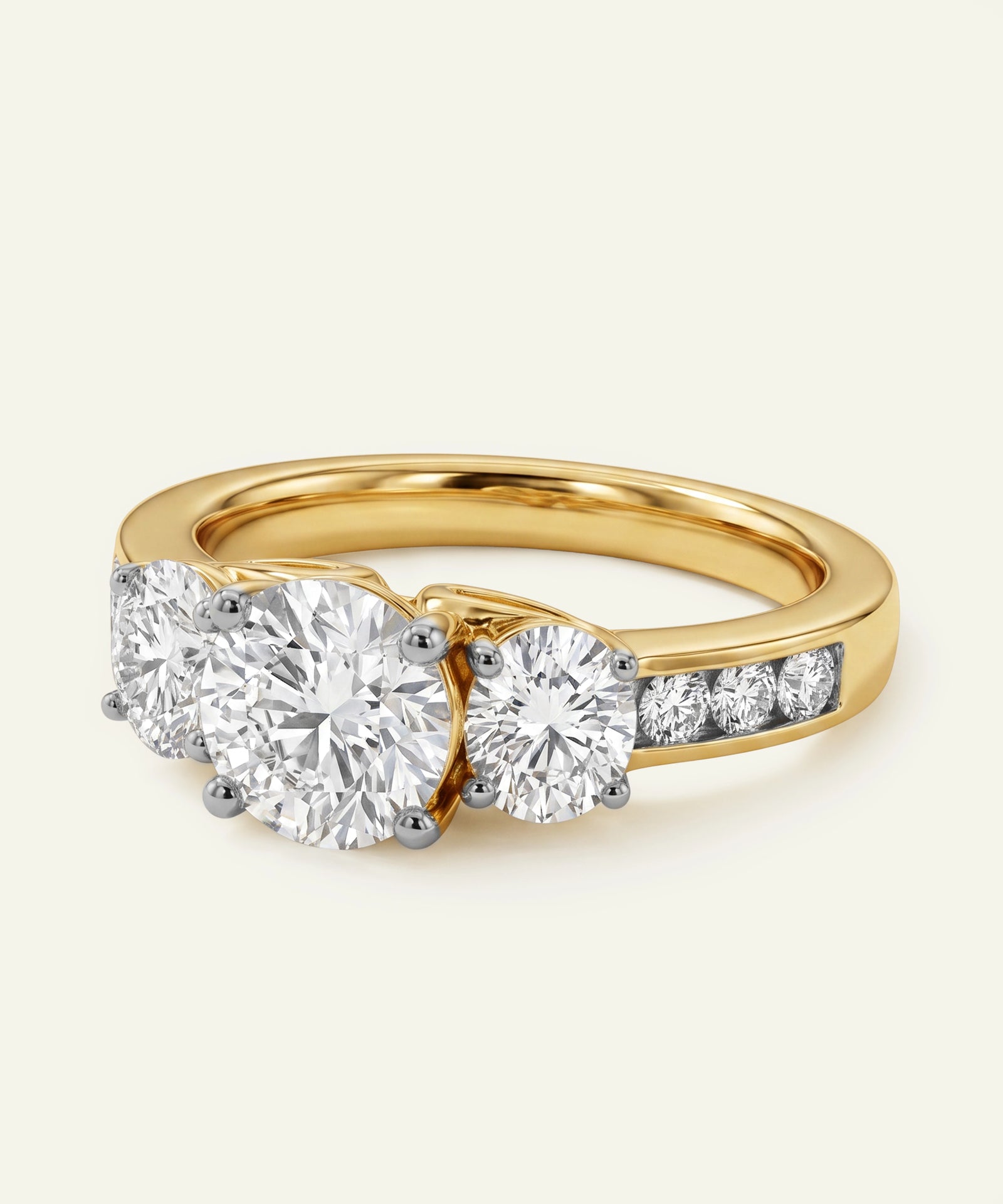 Gold ring with three diamonds on a light background