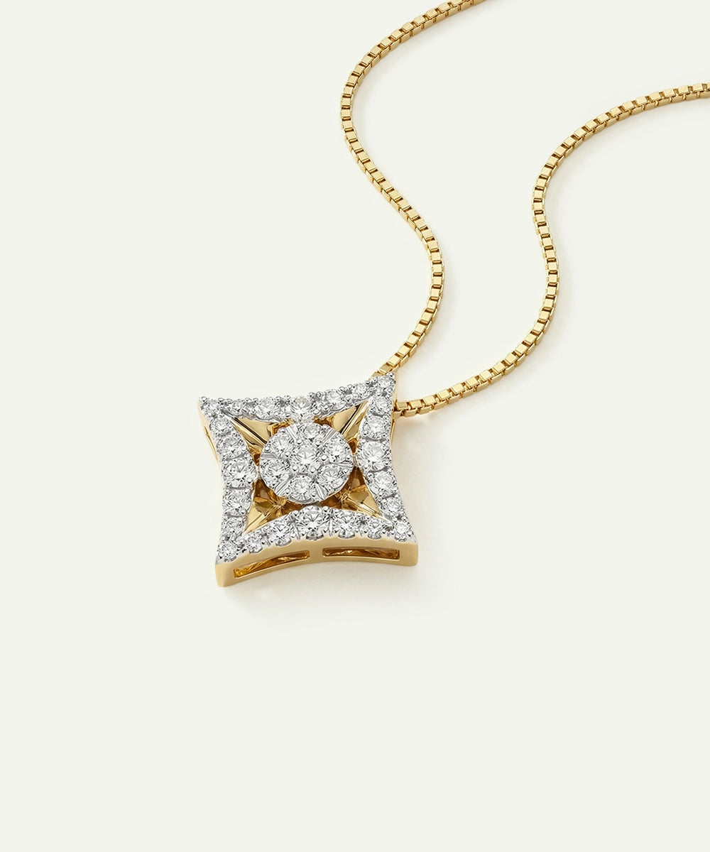Gold necklace with a diamond pendant on a white background