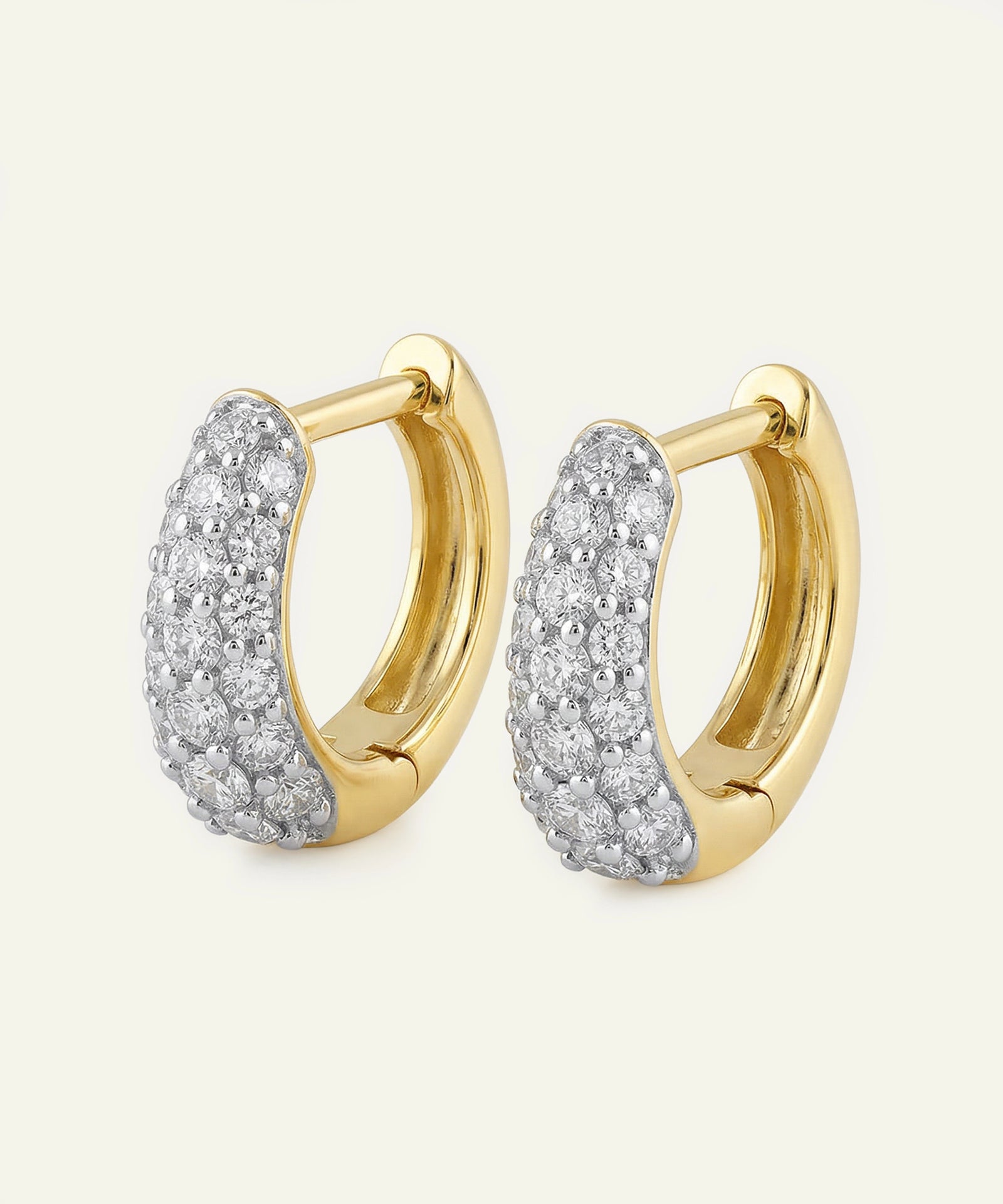 Gold hoop earrings with diamond accents on a white background