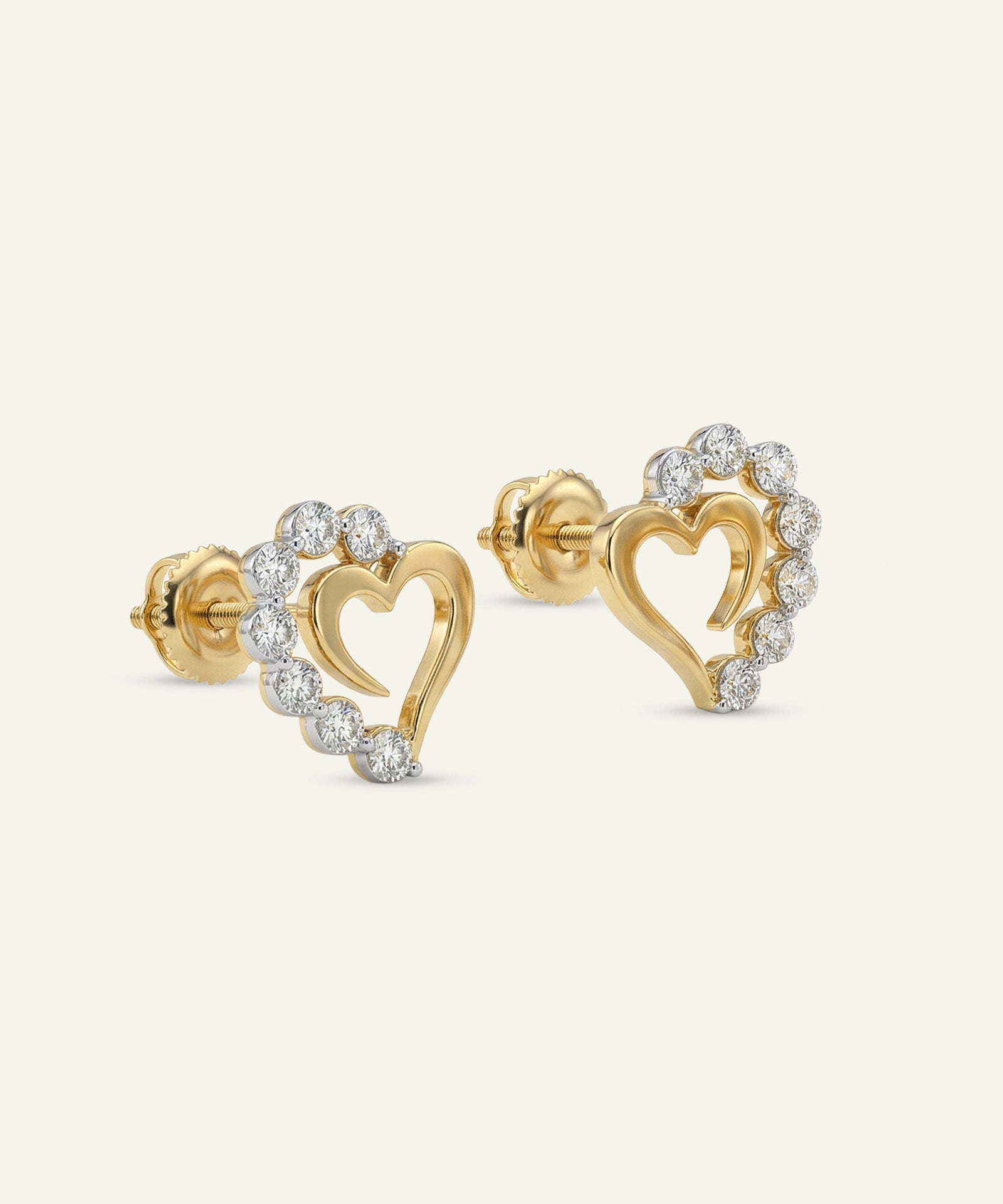 Gold heart-shaped earrings with diamond accents on a white background