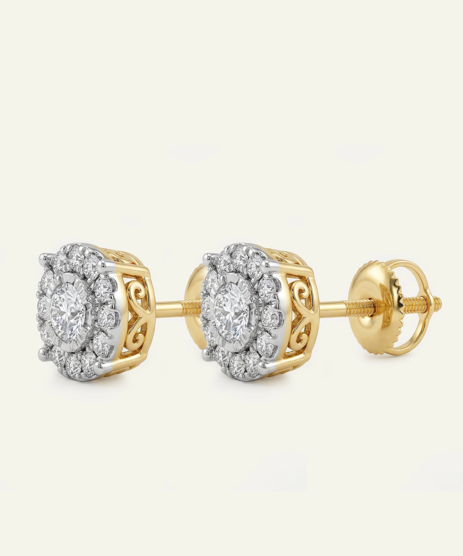 Gold earrings with diamond-like stones on a white background