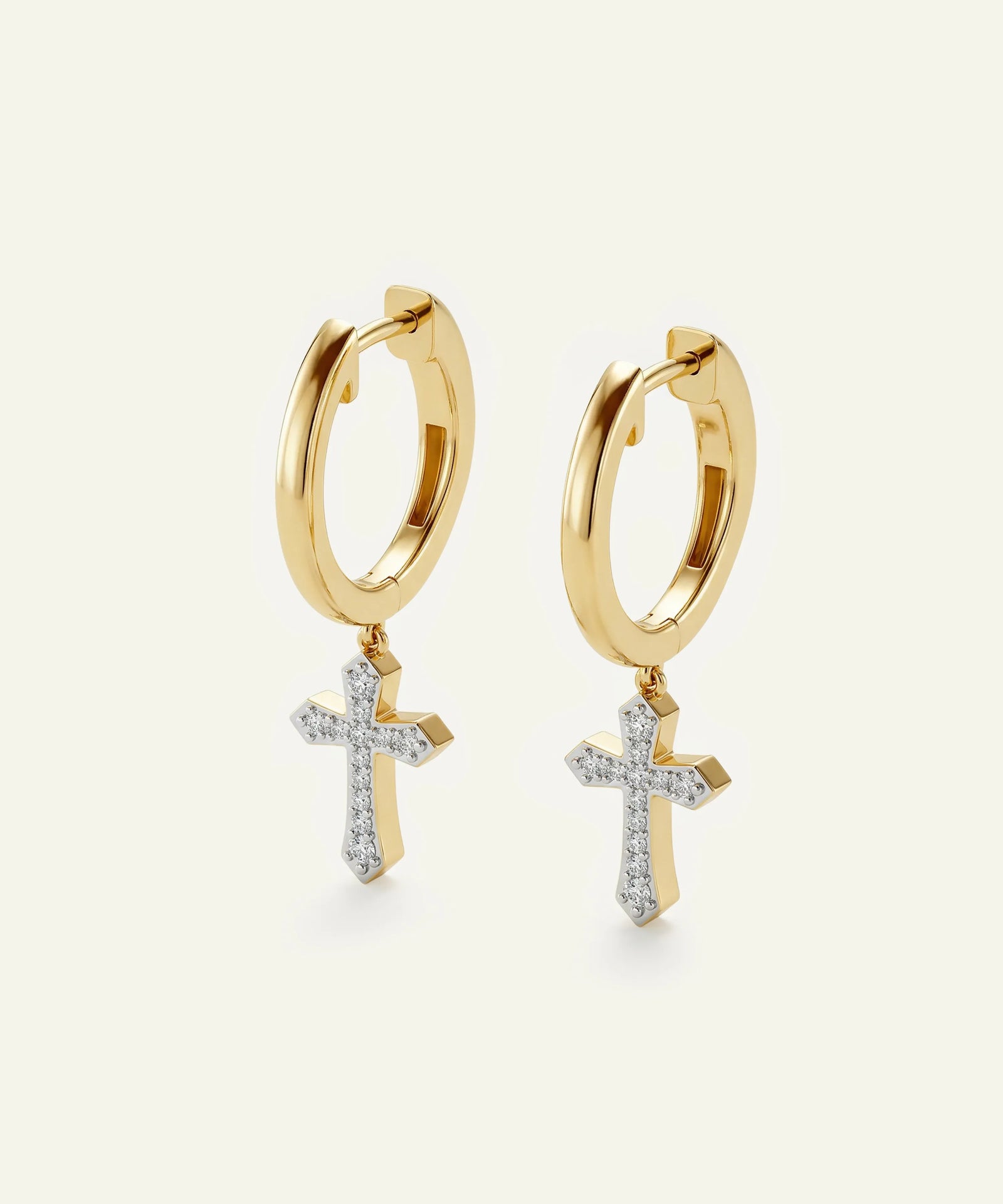 Gold hoop earrings with cross pendants on a white background