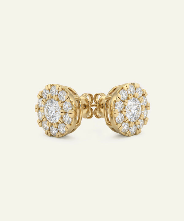 Gold earrings with diamond accents on a white background
