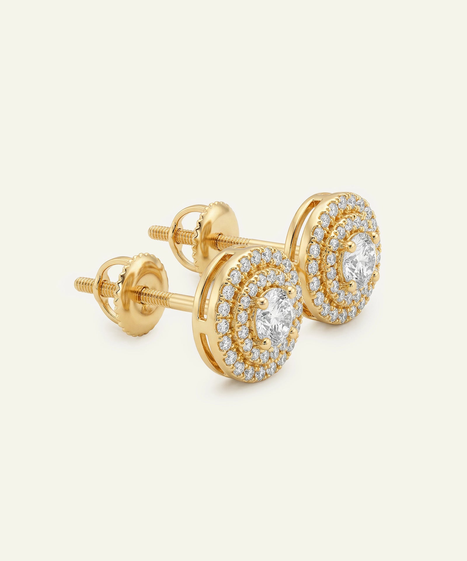 Gold earrings with diamond accents on a white background
