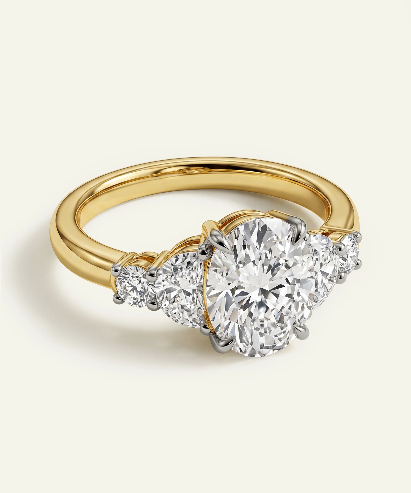 Gold ring with a large diamond and smaller diamonds on a light background