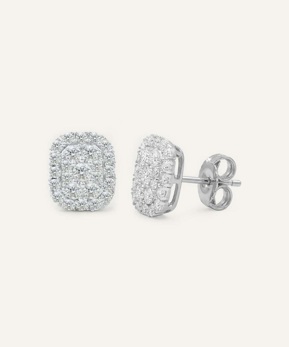 Silver earrings with clear gemstones on a light gray background