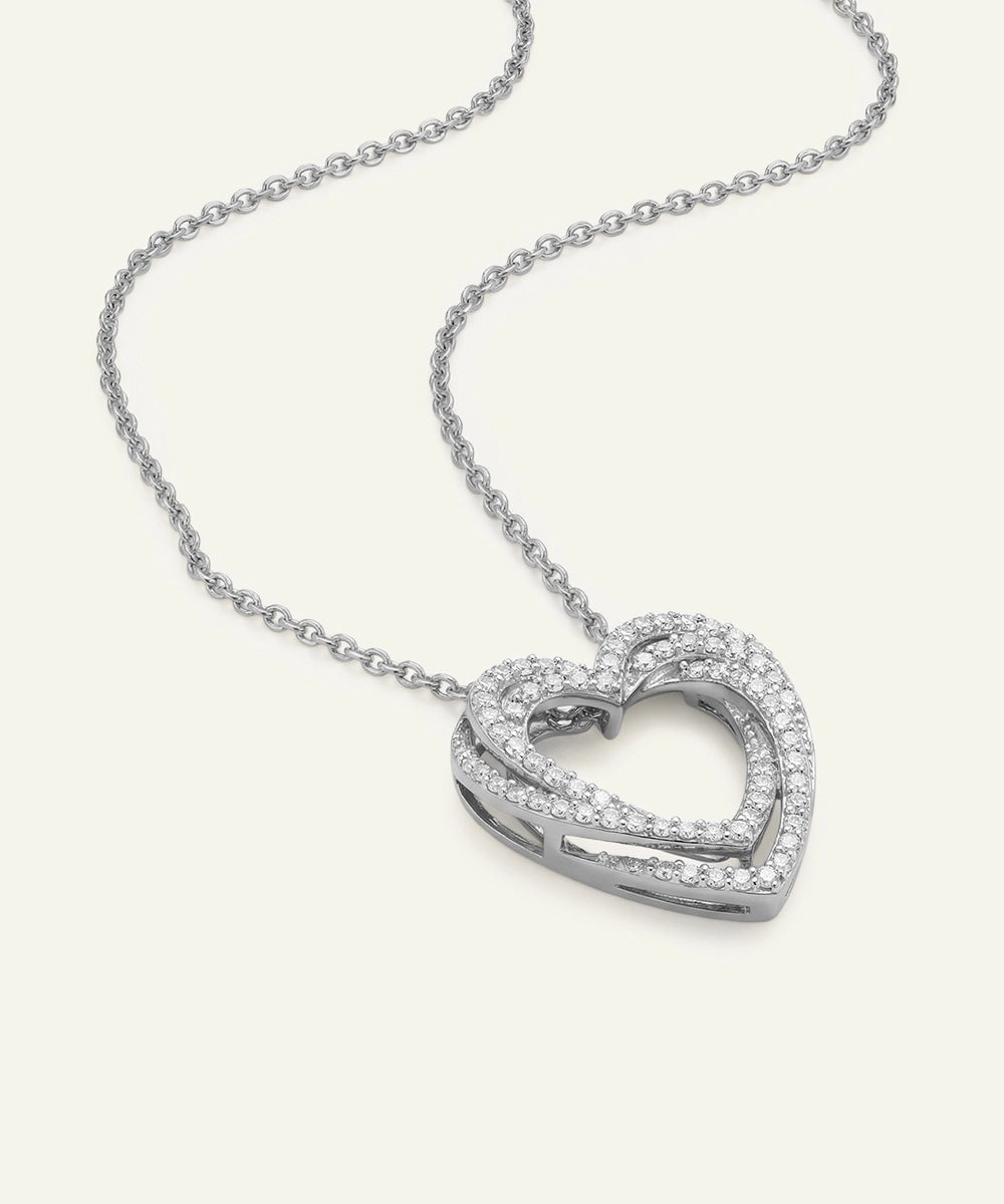 Silver heart-shaped necklace on a white background