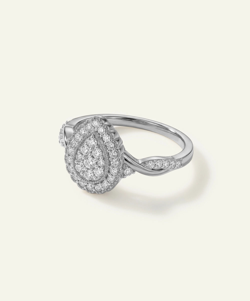 Silver ring with diamond accents on a light gray background