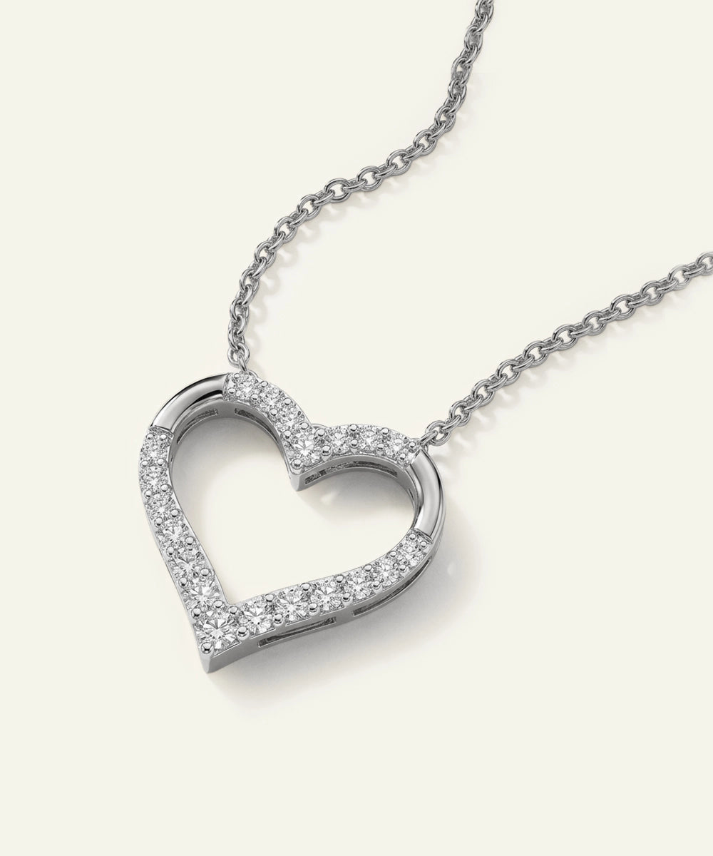 Heart-shaped diamond necklace on a white background