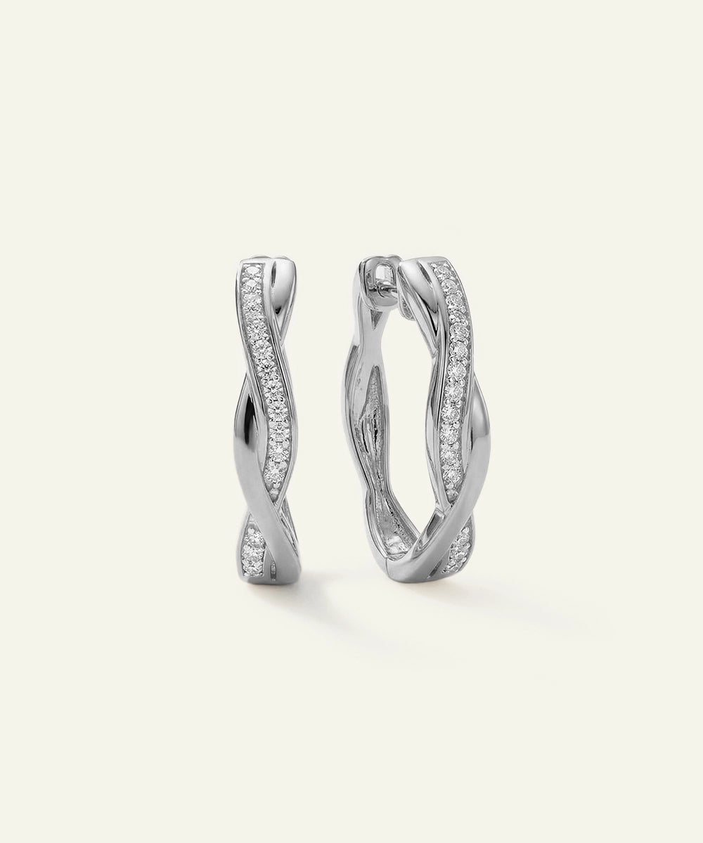 Pair of silver hoop earrings on a light gray background