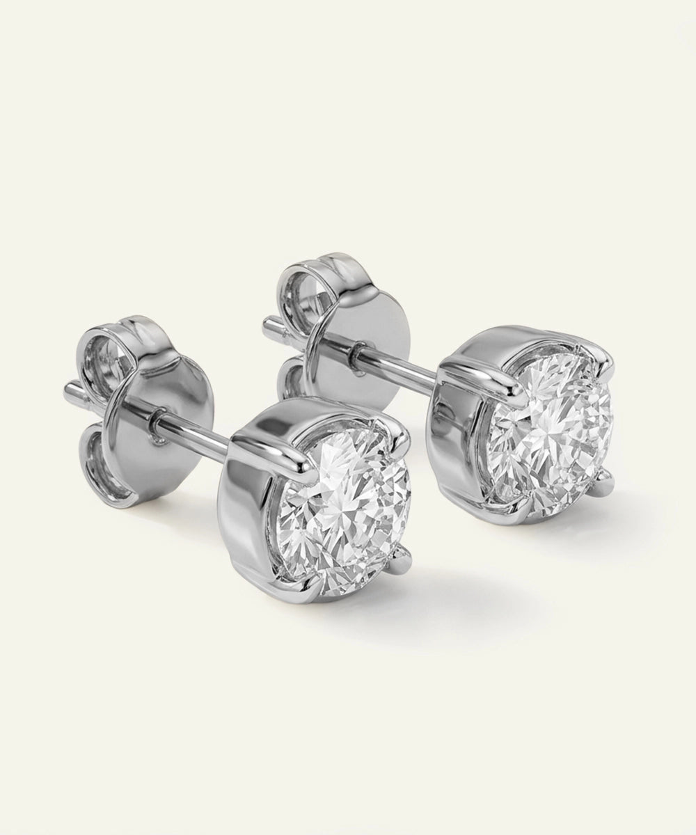Pair of diamond stud earrings on a white background
