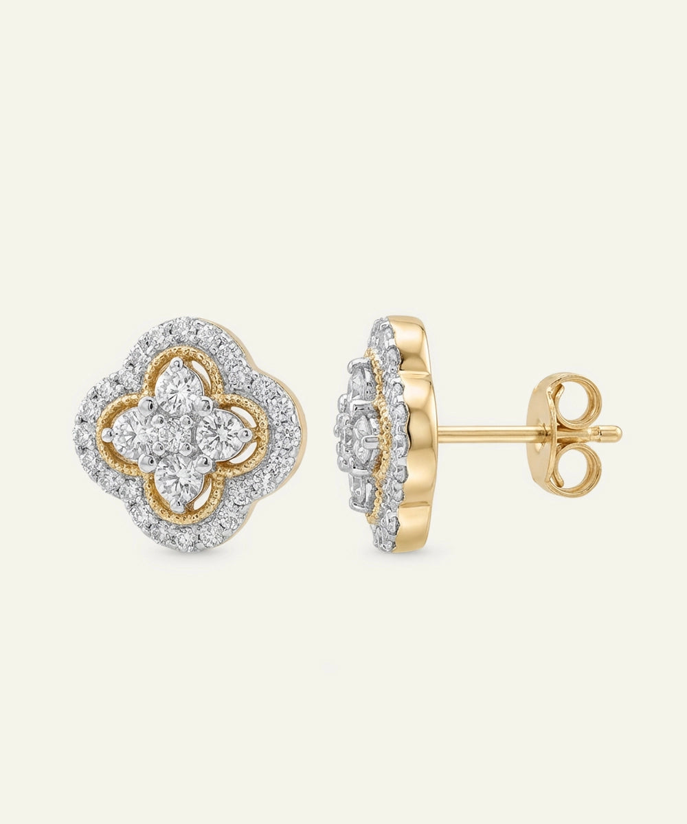 Gold and silver earrings on a light beige background