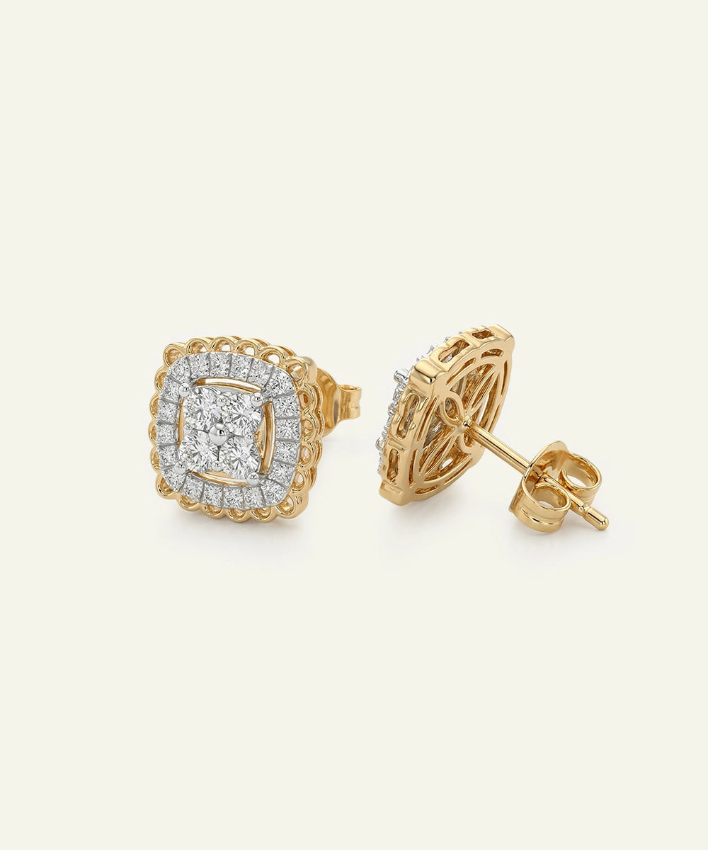 Gold earrings with diamond accents on a light gray background